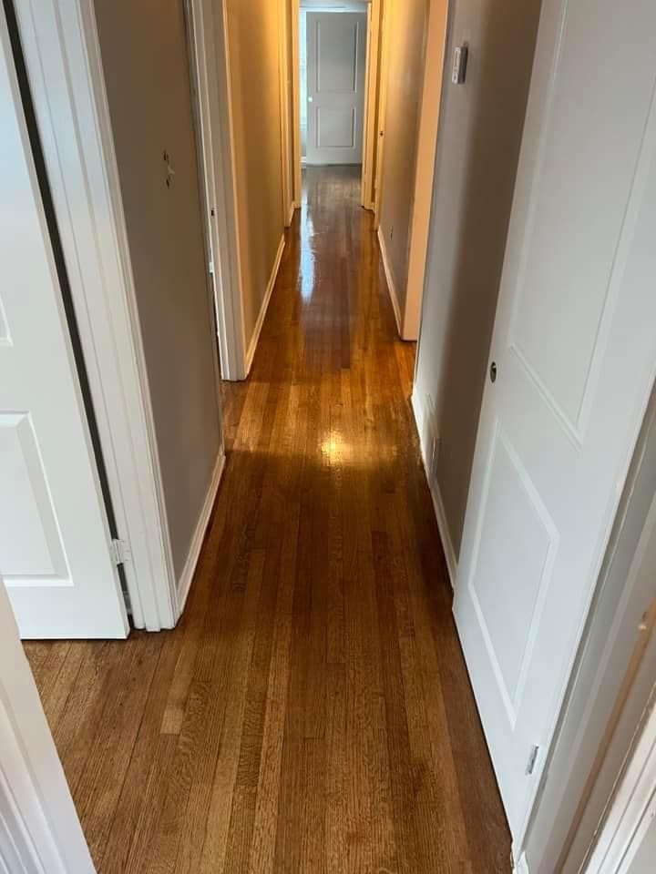 Hallway after — beautifully stained and glossy hardwood